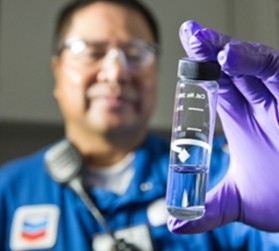 Person in lab holding glass container