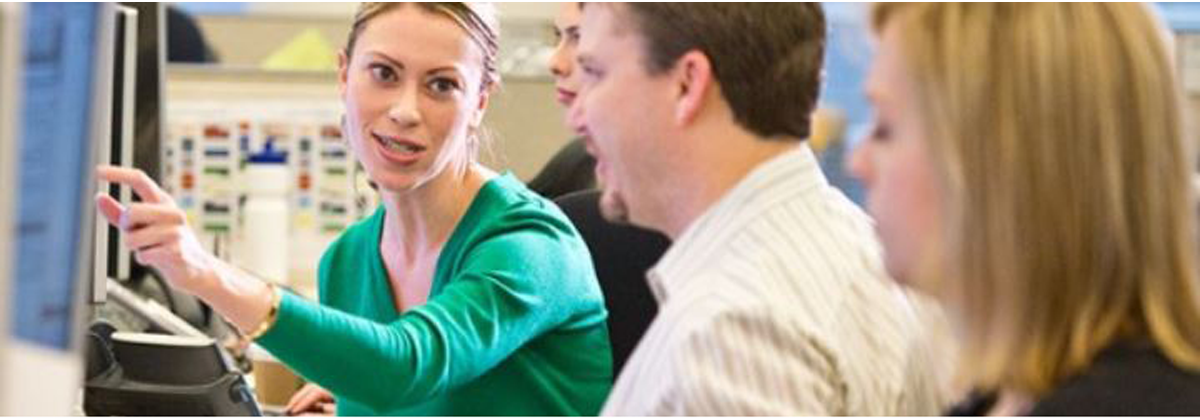 Men and women in front of computer screen
