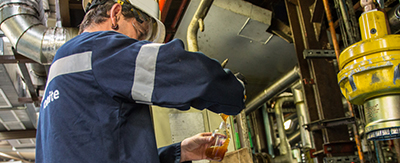 Worker checking oil