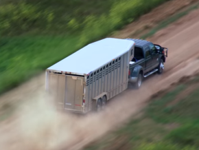 Truck and trailer on dirt road